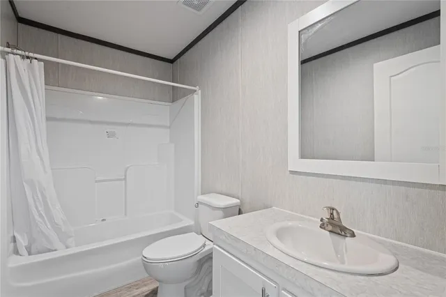 a view of a house with backyard and trees