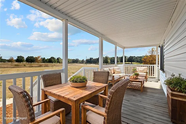 a kitchen with stainless steel appliances granite countertop a sink a stove a refrigerator cabinets and chairs