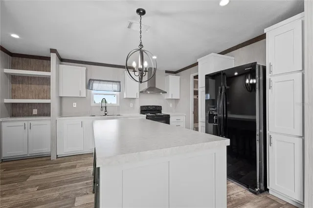 a bedroom with a bed and a potted plant