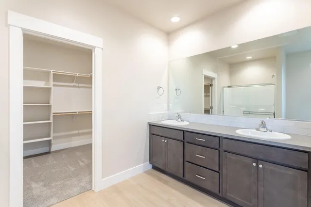 a bathroom with a double vanity sink and a mirror