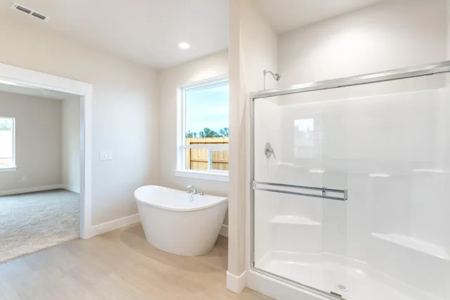 a spacious bathroom with a bathtub and shower
