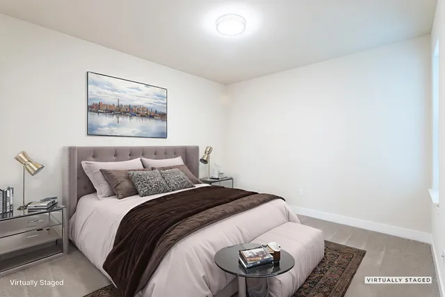 a bedroom with a bed and a painting on the wall