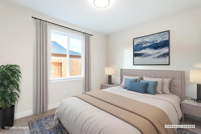 a bedroom with a bed and a painting on the wall