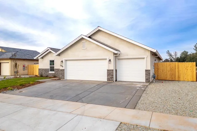 a view of a house with a yard and garage
