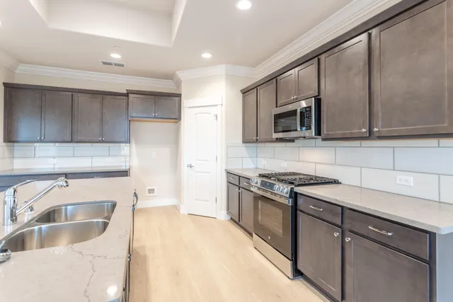a kitchen with granite countertop a sink and a stove top oven