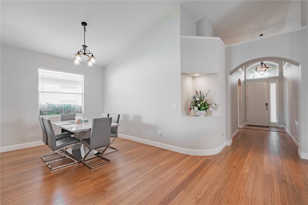 18028 Java Isle Drive Tampa, FL 33647 - Photo 29 of 53 a view of a dining room with furniture window and wooden floor