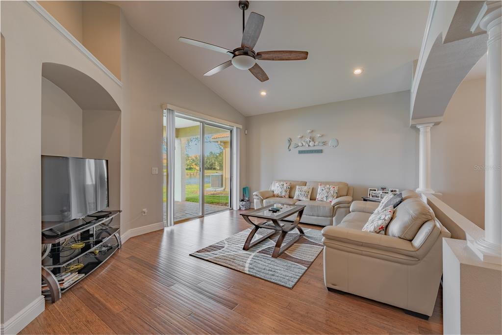 18028 Java Isle Drive Tampa, FL 33647 - Photo 32 of 53 a living room with furniture and a flat screen tv