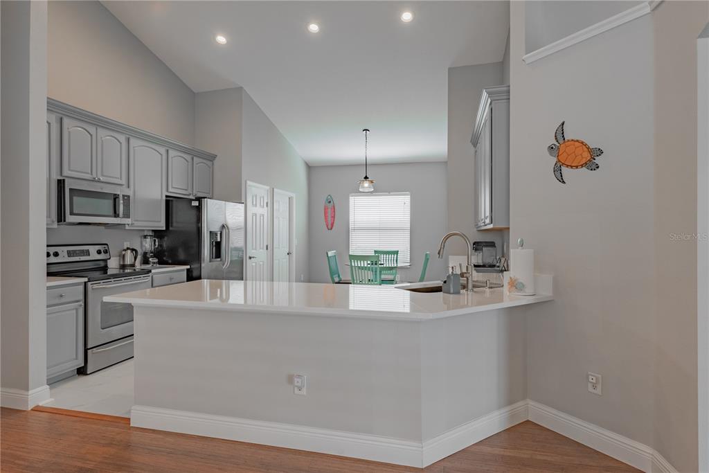 18028 Java Isle Drive Tampa, FL 33647 - Photo 34 of 53 a large kitchen with kitchen island a sink stainless steel appliances and cabinets