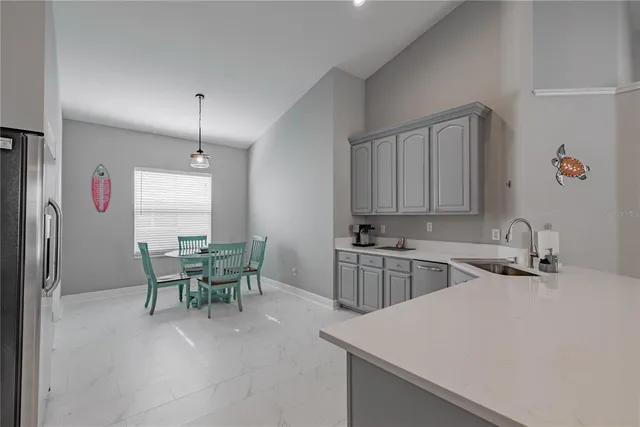 a kitchen with a sink stainless steel appliances and cabinets