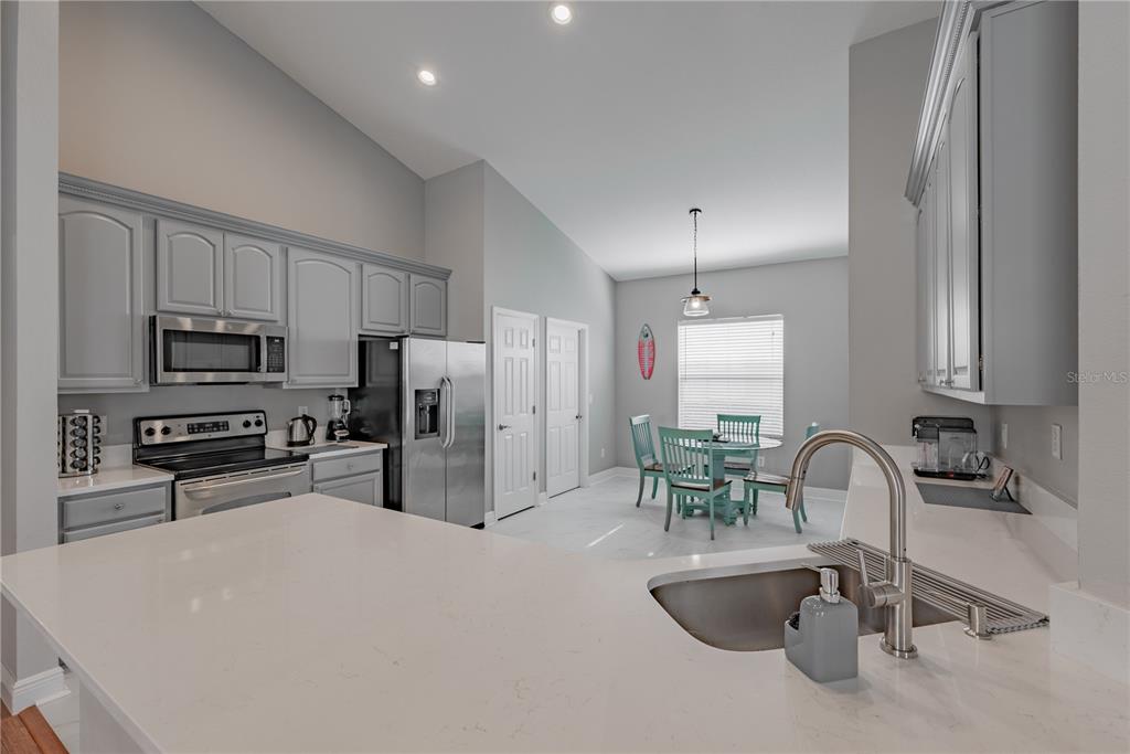 18028 Java Isle Drive Tampa, FL 33647 - Photo 36 of 53 a kitchen with stainless steel appliances granite countertop a sink and a refrigerator