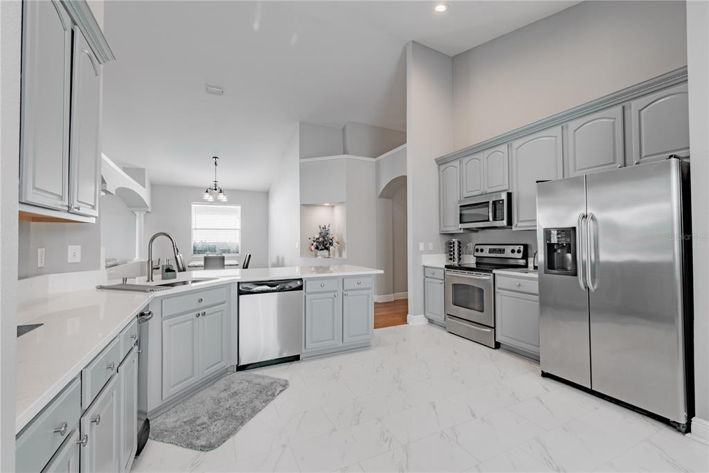 18028 Java Isle Drive Tampa, FL 33647 - Photo 38 of 53 a kitchen with a sink stainless steel appliances and cabinets