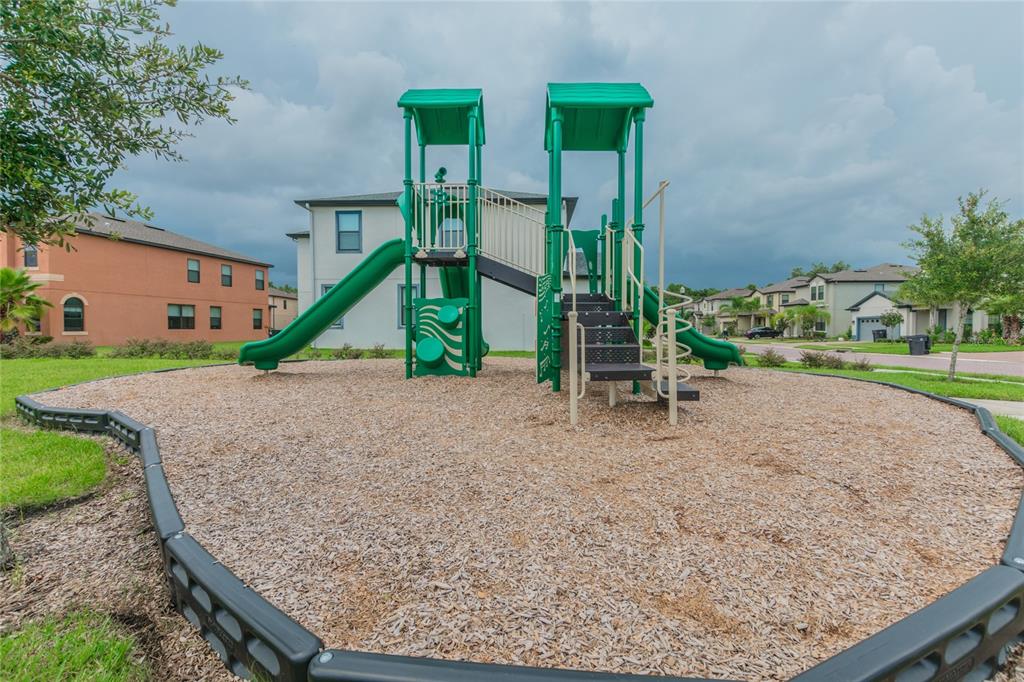 18028 Java Isle Drive Tampa, FL 33647 - Photo 46 of 53 a park view with a bench and trees