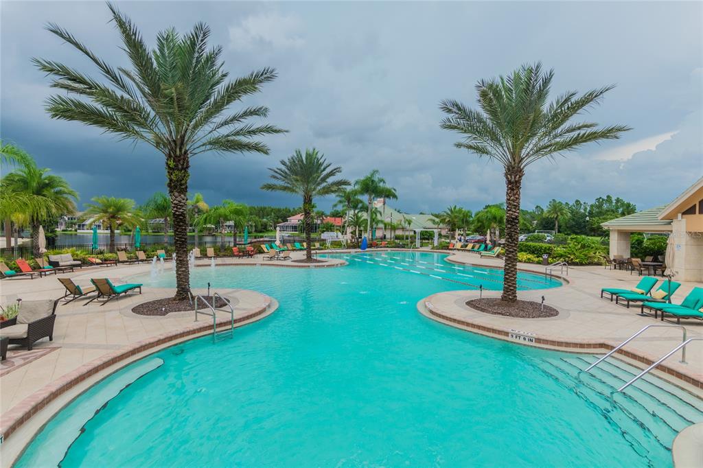 18028 Java Isle Drive Tampa, FL 33647 - Photo 49 of 53 a view of a swimming pool with a table and chairs