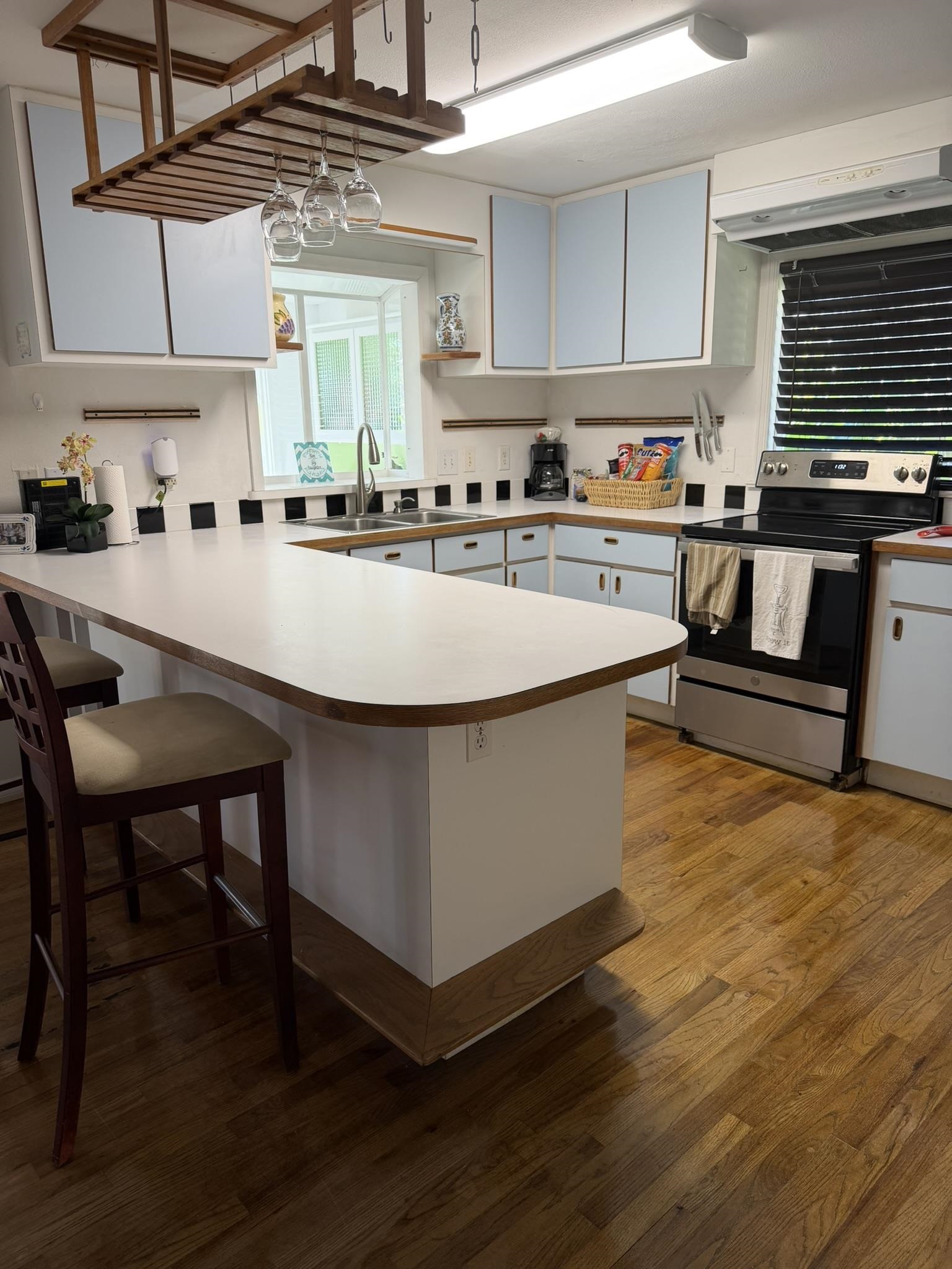 404 Fifteenth Street St. Augustine, FL 32084 - Photo 16 of 23 a living room with stainless steel appliances granite countertop a kitchen island a stove a sink a refrigerator and cabinets