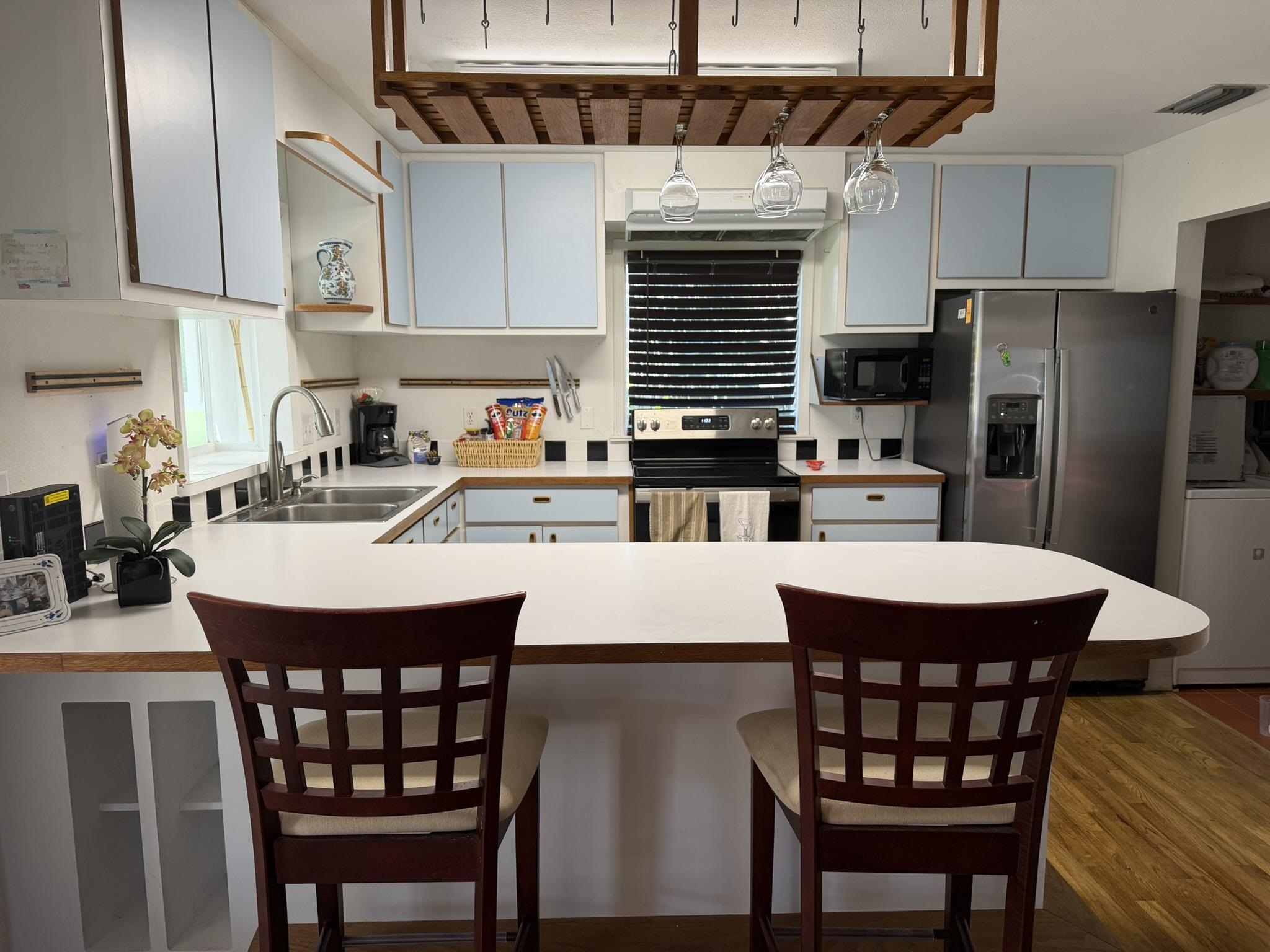 404 Fifteenth Street St. Augustine, FL 32084 - Photo 18 of 23 a kitchen with stainless steel appliances a table chairs and a refrigerator