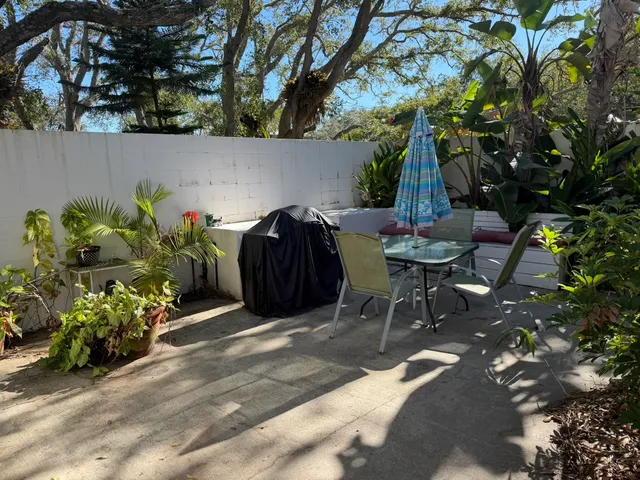 a view of a chairs and tables in the backyard of a house