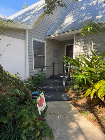 a backyard of a house with outdoor seating