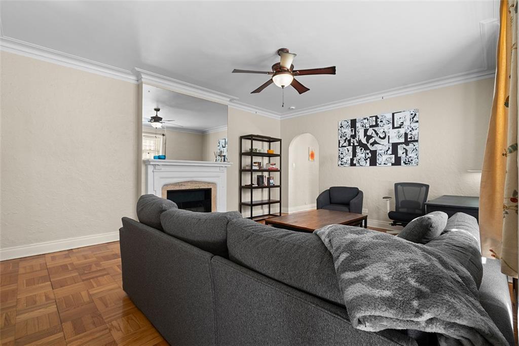 166 North Dithridge Street, Unit 1E Pittsburgh, PA 15213 - Photo 12 of 31 a living room with a couch and a fireplace