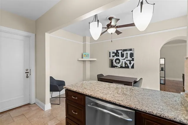 a kitchen with a counter and a view of living room