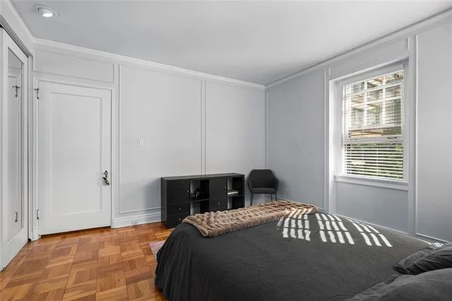 a bedroom with a bed and window