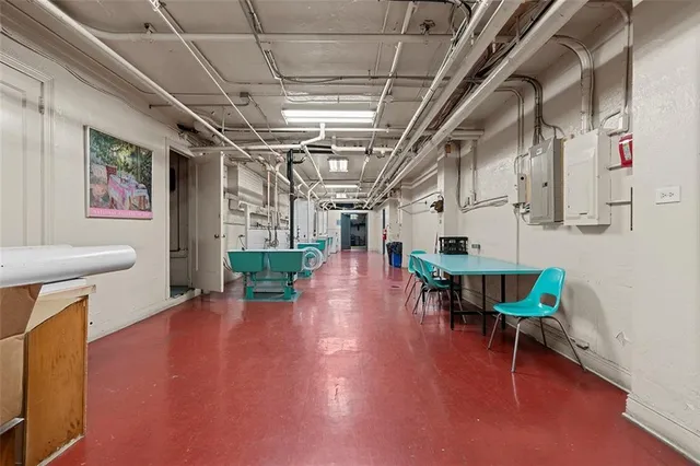 a view of a room with furniture a rug and a kitchen