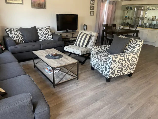 a living room with furniture and a flat screen tv