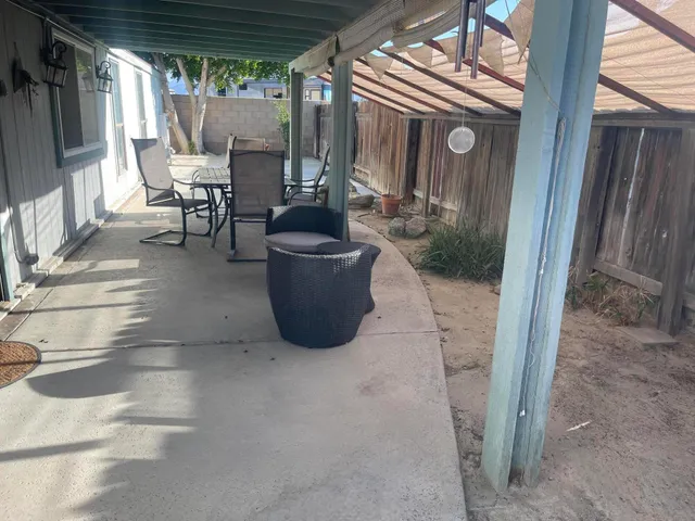 a view of an outdoor dining space with a porch