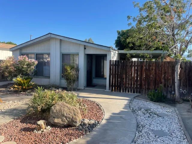 a view of house with backyard and garden