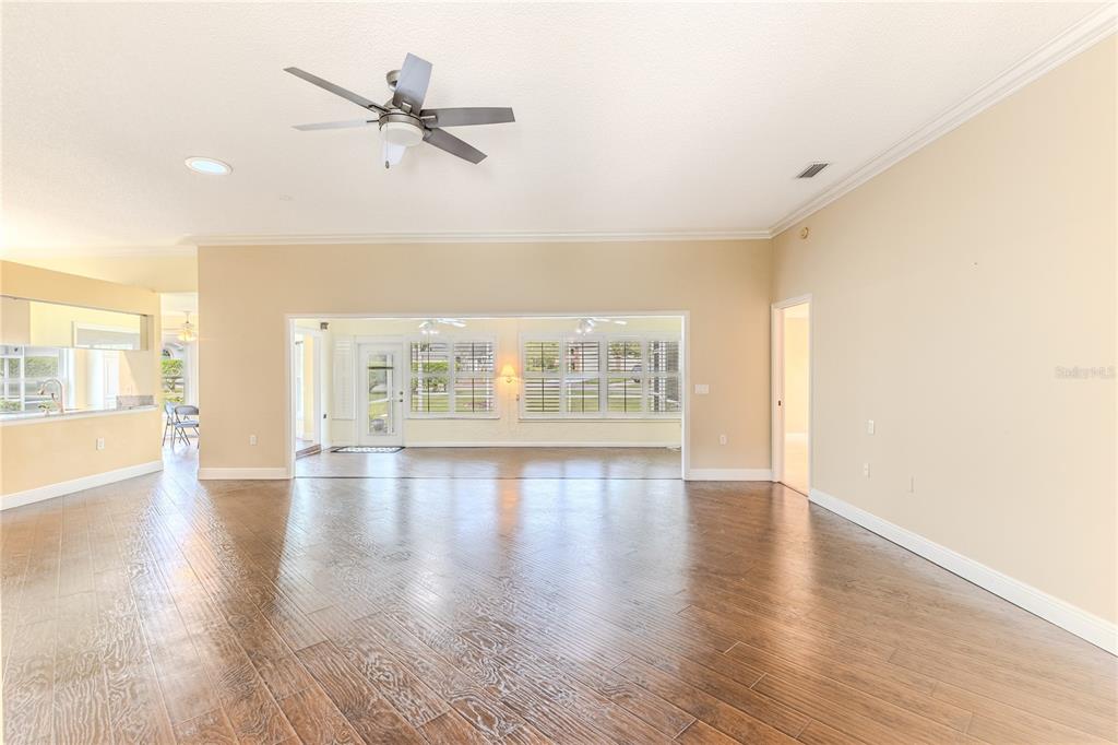 2181 Terrace View Lane Spring Hill, FL 34606 - Photo 11 of 60 an empty room with wooden floor fan and windows