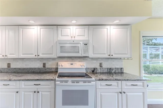 a large kitchen with a sink and cabinets