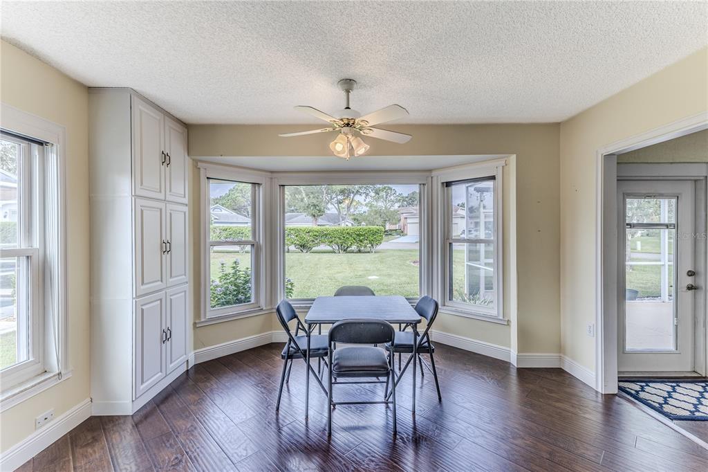 2181 Terrace View Lane Spring Hill, FL 34606 - Photo 22 of 60 a dining room with furniture window and wooden floor