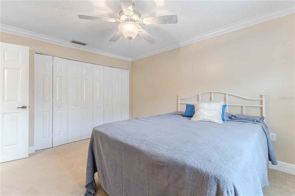 2181 Terrace View Lane Spring Hill, FL 34606 - Photo 26 of 60 a bedroom with a bed and a chandelier