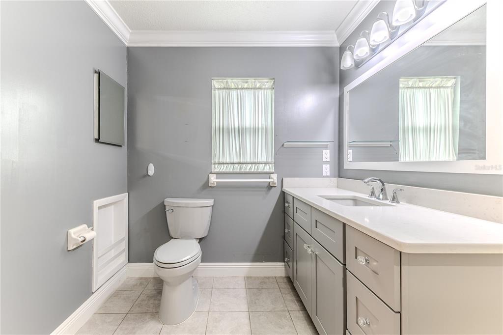 2181 Terrace View Lane Spring Hill, FL 34606 - Photo 39 of 60 a spacious bathroom with a granite countertop sink a toilet and a window