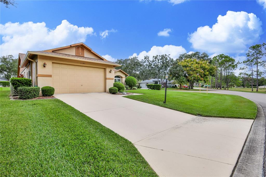 2181 Terrace View Lane Spring Hill, FL 34606 - Photo 4 of 60 a front view of a house with a yard and garage