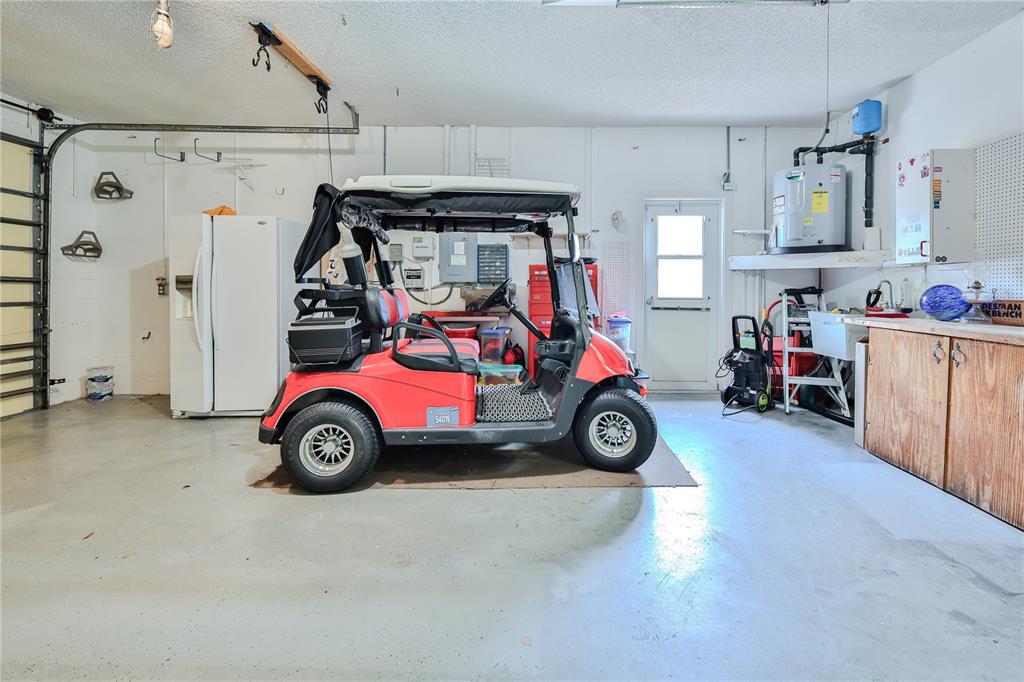 2181 Terrace View Lane Spring Hill, FL 34606 - Photo 47 of 60 a view of a garage with a car and a car