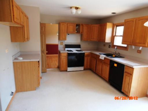 416 Fawn Lane Oswego, IL 60543 - Photo 3 of 15 a kitchen with stainless steel appliances granite countertop a sink stove and refrigerator