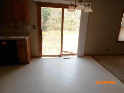 416 Fawn Lane Oswego, IL 60543 - Photo 4 of 15 a view of an empty room with a window