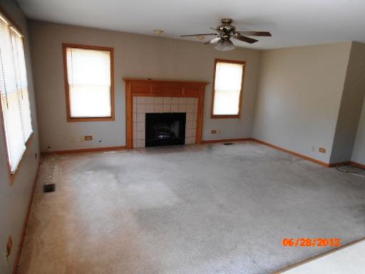 416 Fawn Lane Oswego, IL 60543 - Photo 5 of 15 an empty room with windows and fireplace