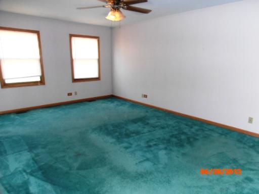 416 Fawn Lane Oswego, IL 60543 - Photo 8 of 15 an empty room with a window and kitchen view
