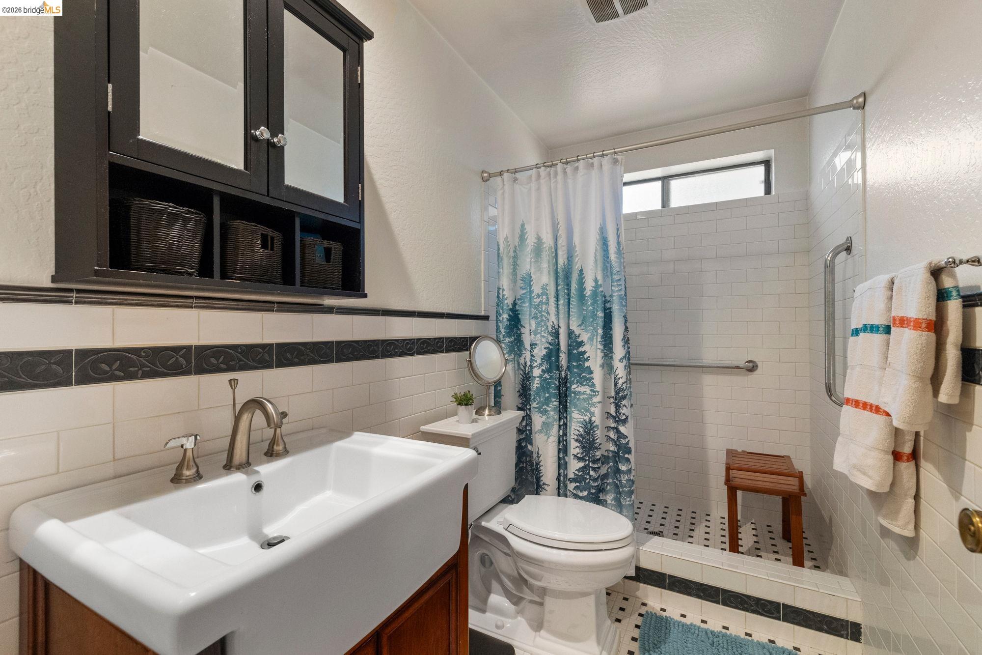 23615 Elizabeth Peak Road Twain Harte, CA 95383 - Photo 12 of 38 Full bath with vanity, tile walls, a textured wall, a shower stall, and wainscoting