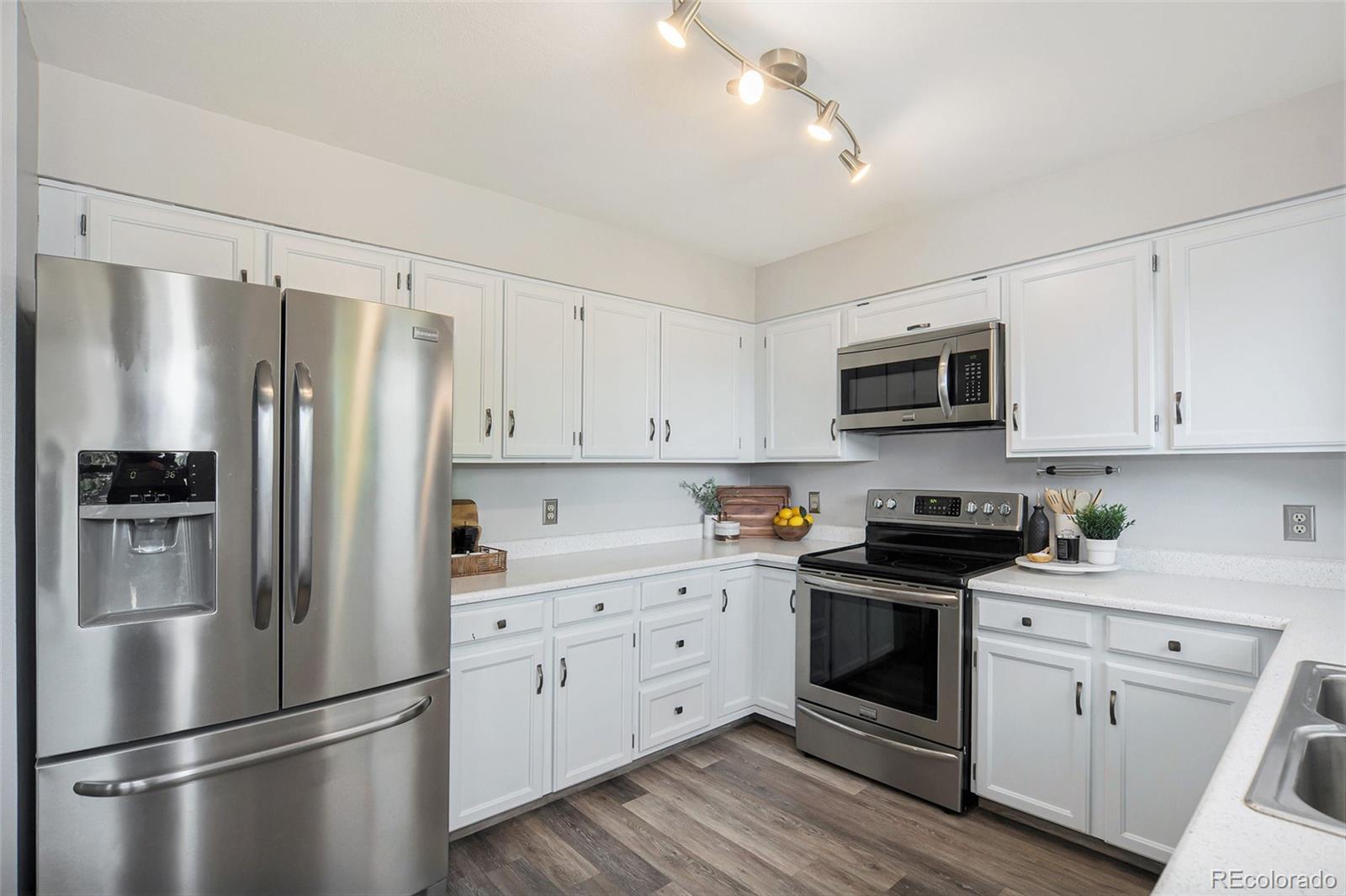 11820 Wyandot Circle Denver, CO 80234 - Photo 12 of 35 a kitchen with stainless steel appliances a refrigerator sink and cabinets