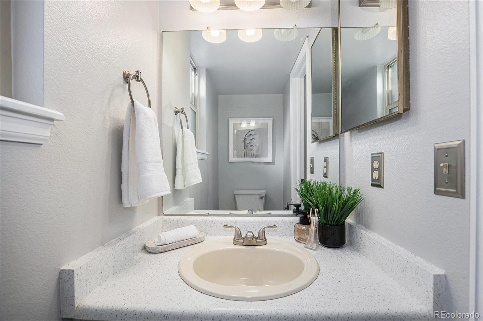 11820 Wyandot Circle Denver, CO 80234 - Photo 13 of 35 a bathroom with a sink and a mirror