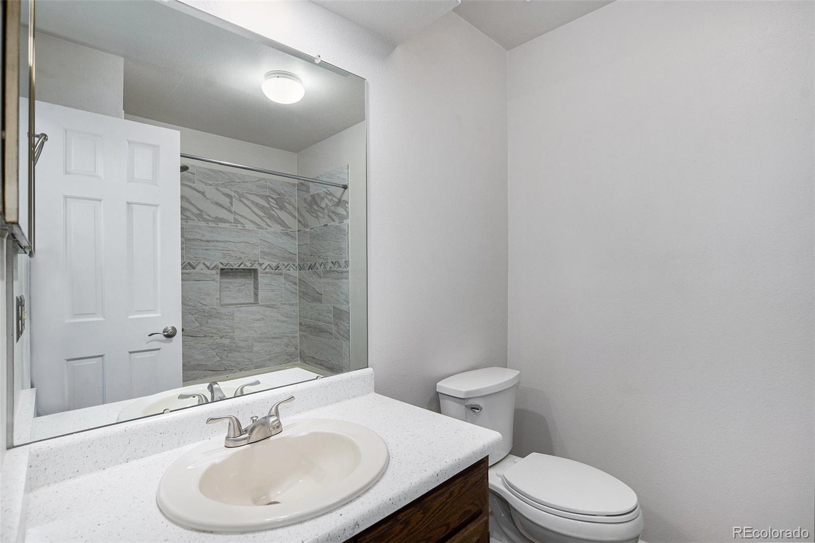 11820 Wyandot Circle Denver, CO 80234 - Photo 22 of 35 a bathroom with a sink toilet and shower