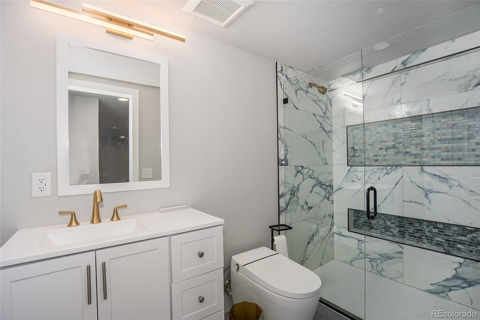 11820 Wyandot Circle Denver, CO 80234 - Photo 24 of 35 a bathroom with a sink toilet and shower