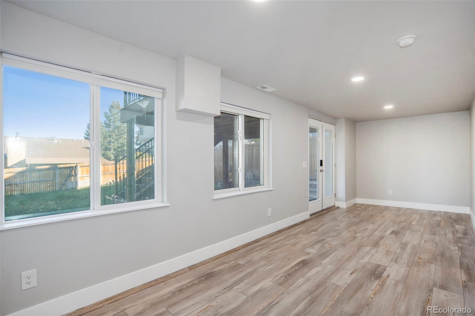 11820 Wyandot Circle Denver, CO 80234 - Photo 25 of 35 a view of an empty room with wooden floor and a window