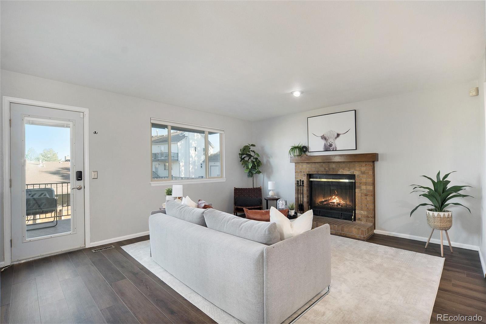 11820 Wyandot Circle Denver, CO 80234 - Photo 7 of 35 a living room with furniture and a fireplace
