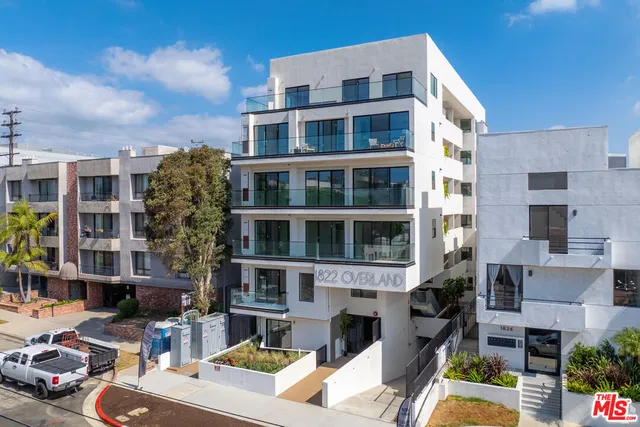 a view of a building with garden and sitting area