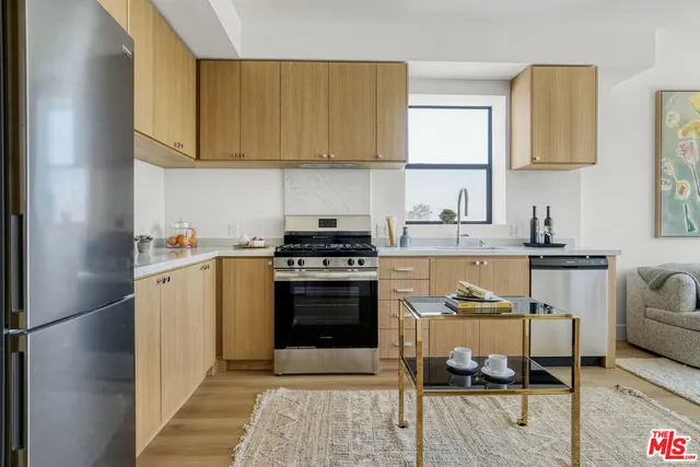 a kitchen with a sink cabinets and stainless steel appliances