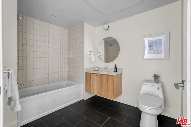 a bathroom with a toilet a sink and bathtub