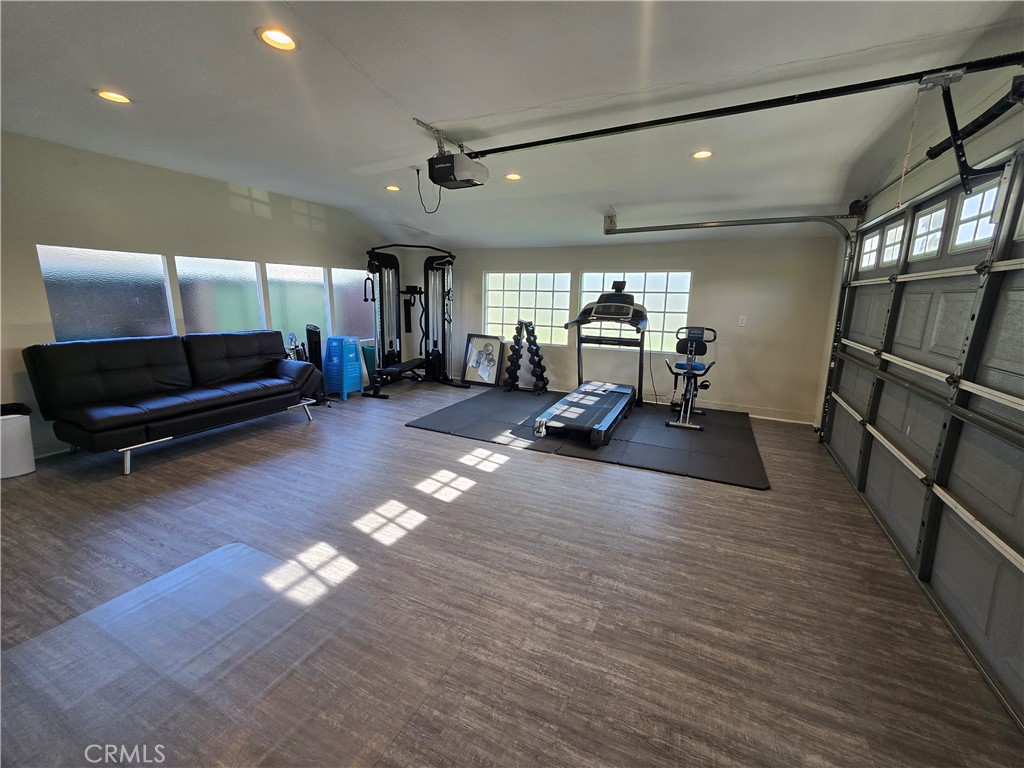 1925 South Kathy Lane Anaheim, CA 92802 - Photo 5 of 12 a living room with furniture gym equipment and a wooden floor